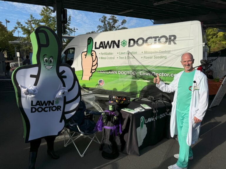 Steve at a community Trunk-or-Treat event with the Lawn Doctor mascot